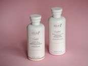 White Keune shampoo and conditioner bottles on a soft pink background.