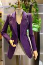 Elegant purple tailored jacket displayed on a mannequin indoors.