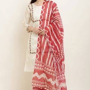 Woman wearing traditional Indian attire with dupatta, posing elegantly in a studio.